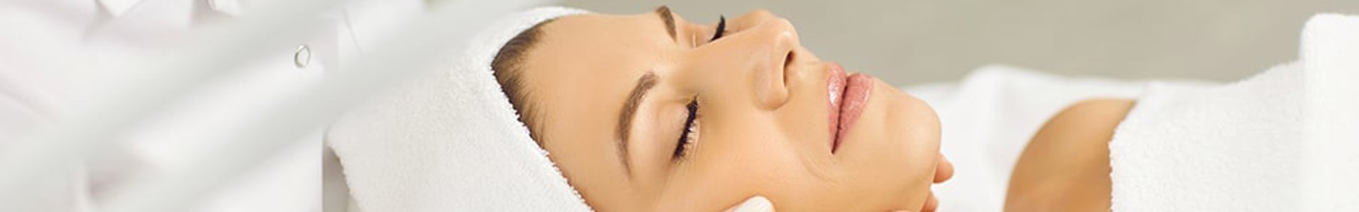 Patient receiving a professional facial treatment at Mubadala Health Dubai clinic.