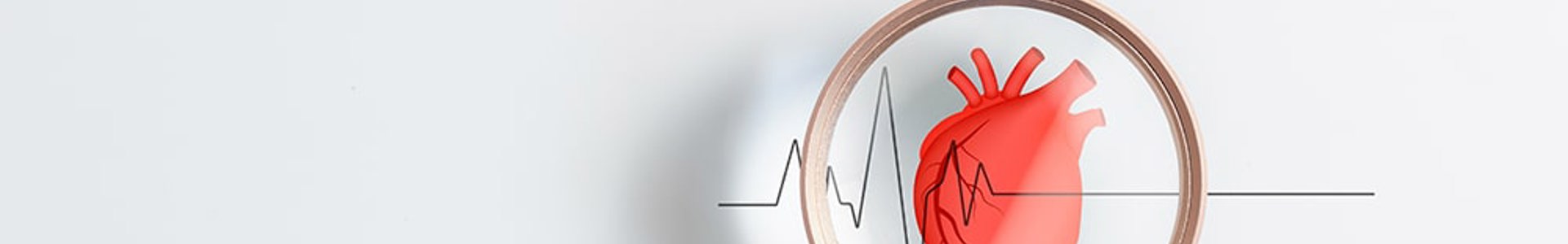 Gloved hand holding a magnifying glass over a heart and heartbeat line, representing cardiac health screening